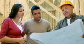 contractor reviewing plans with homeowners
